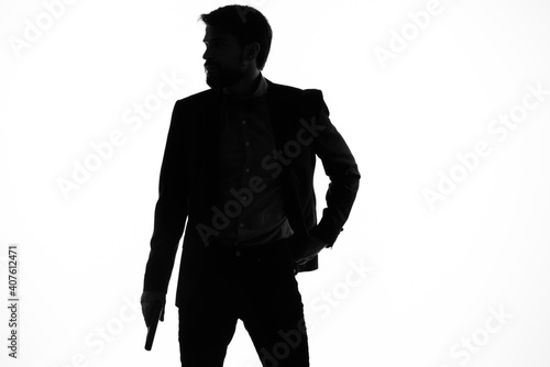 Fotografija portrait of a man shadow gun in the hands of a detective crime incognito