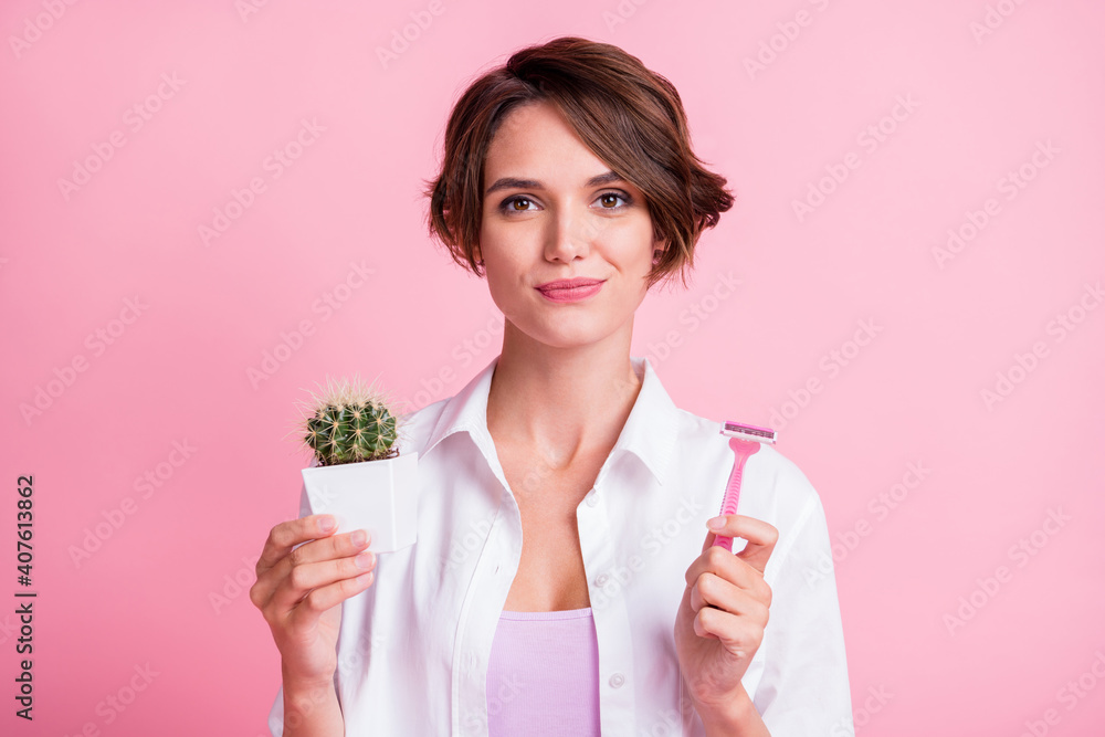Photo of pretty hairdo person charming face holding razor little cactus flower isolated on pink color background Photo of pretty hairdo person charming face holding razor little cactus flower isolated on pink color background