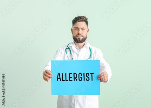 Portrait of male doctor hol...