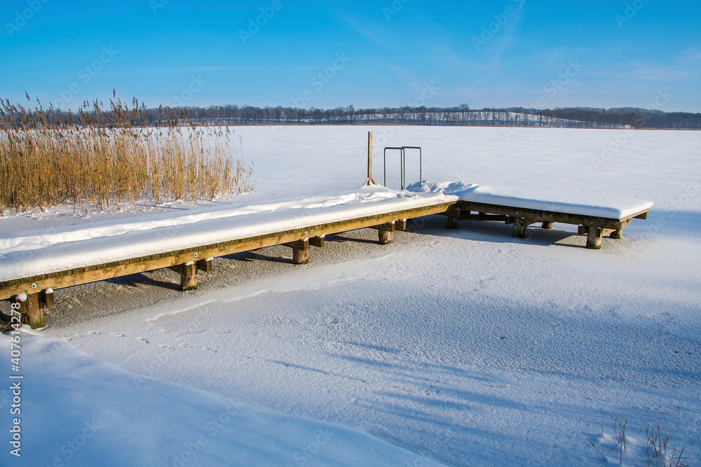 frozen lake and pier, beautiful winter landscape, Masuria in Poland