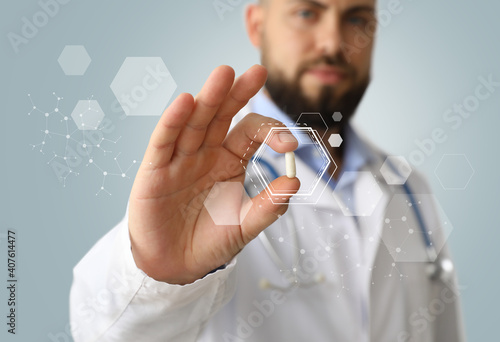 Male doctor holding pill on...