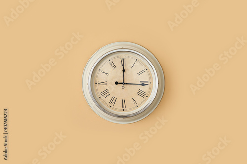 Modern clock hanging on col...