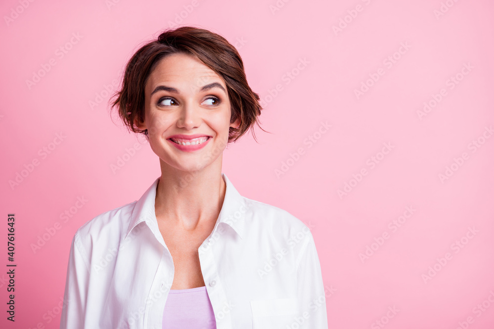 Photo portrait of curious female student looking at blank space in white clothes isolated on pink pastel color background Photo portrait of curious female student looking at blank space in white clothes isolated on pink pastel color background