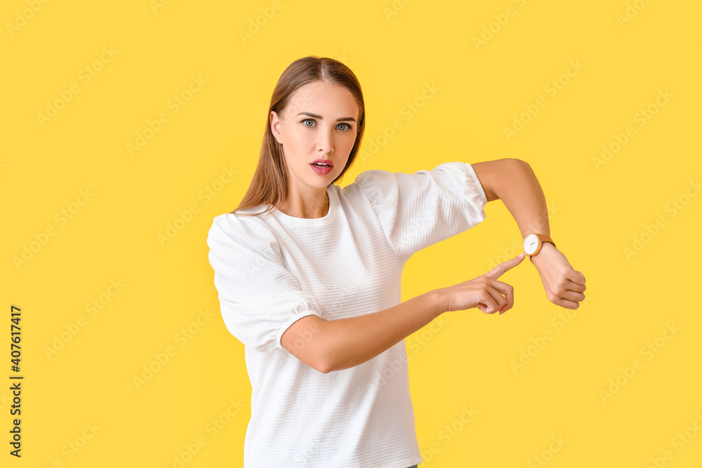 Stressed woman with wristwatch on color background Stressed woman with wristwatch on color background