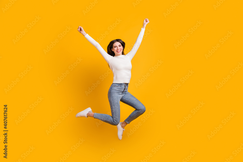 Full size photo of hooray nice girl jump wear sweater jeans sneakers isolated on yellow color background