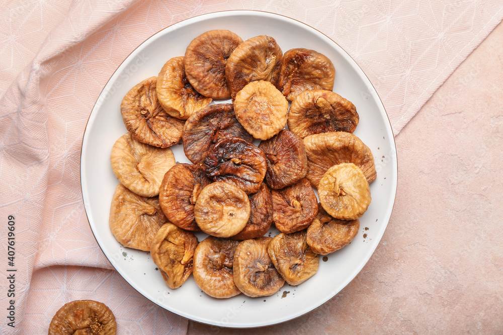 Plate with tasty dried figs on color background Plate with tasty dried figs on color background