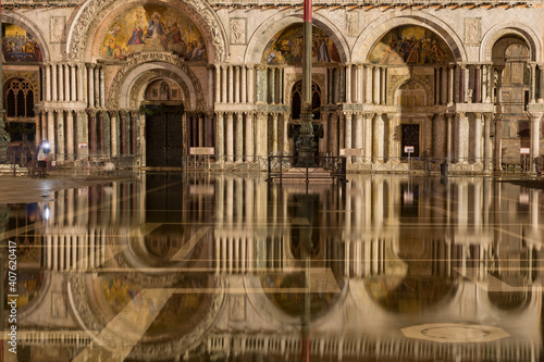 St. Mark's Basilica reflecting in high water flooded St. Mark's Square at night, Venice, Italy