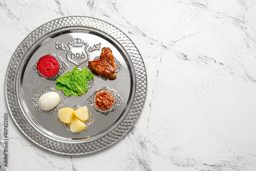 Passover Seder plate with traditional food on white background photo