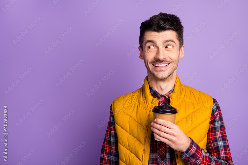 Photo of cute cheerful young guy dressed yellow vest holding brown cup  looking empty space isolated purple color background Stock Photo | Adobe  Stock