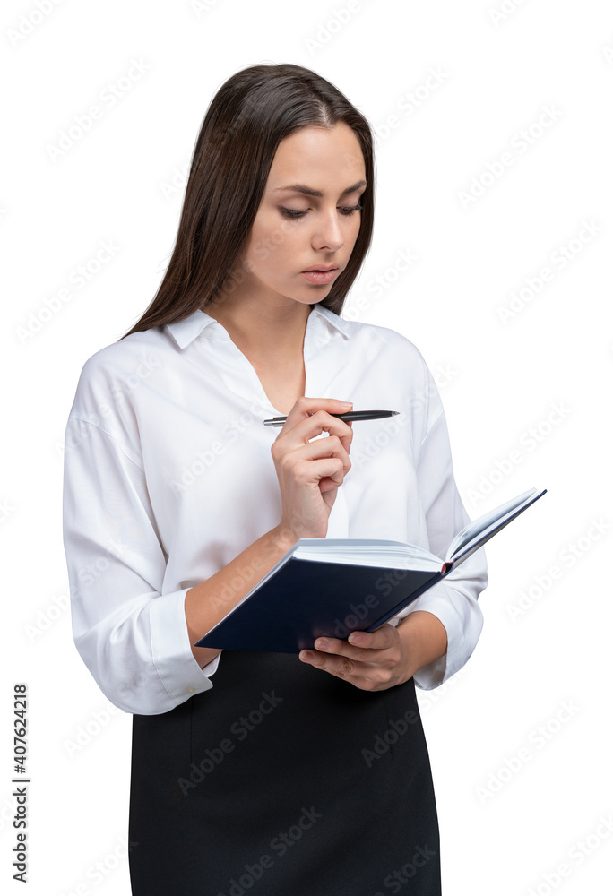 Young businesswoman in white shirt and black skirt with notebook and pen in hands. Female office manager isolated over white background making notes Young businesswoman in white shirt and black skirt with notebook and pen in hands. Female office manager isolated over white background making notes