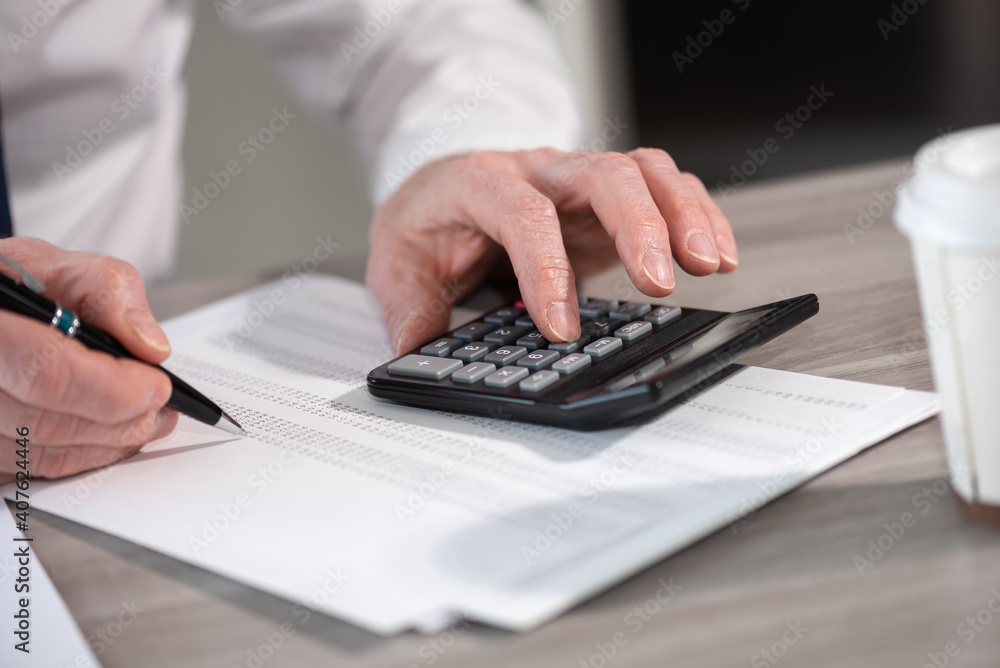 Fototapeta premium Male hands making calculation