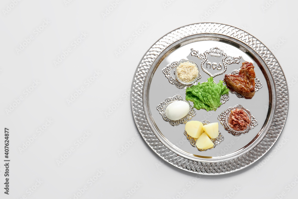 Passover Seder plate with traditional food on light background Passover Seder plate with traditional food on light background