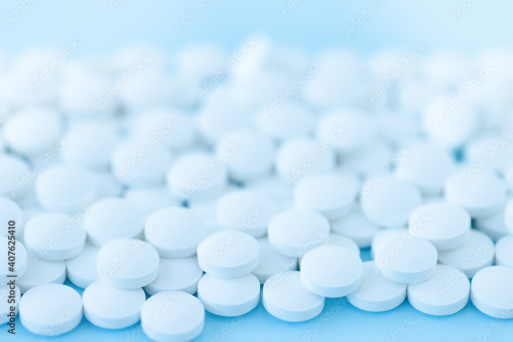 White pills on blue background White pills on blue background