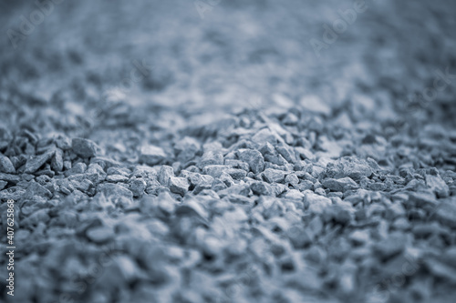 Background of pebbles. Pebble texture with a blue tint. Blue pebbles. Abstract smooth round pebbles texture background.