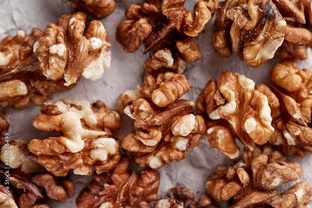 Peeled walnut halves in a pile, isolated on a light gray background, copy the space. Food menu Peeled walnut halves in a pile, isolated on a light gray background, copy the space. Food menu