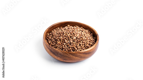 Buckwheat in a wooden bowl isolated on a white background.
