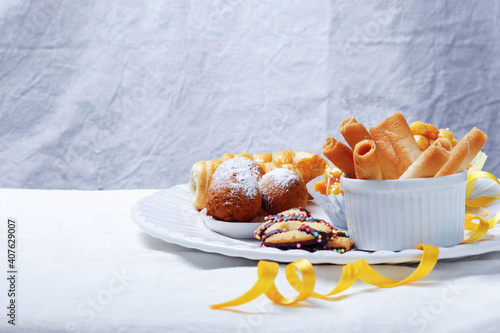 Traditional Carnival Italian fritters dusted sugar with honey and sprinkles. photo