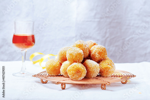 Traditional Carnival Italian fritters dusted sugar with honey and sprinkles. photo