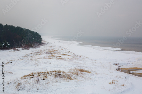 Calm winter seaside scene at the Baltic sea on a cloudy day in January in Saulkrasti in Latvia