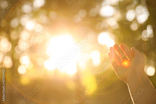 Young woman enjoying beautiful sunset, closeup view with space for text. Nature healing power