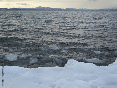 freezing sea, steel water and floating ice floes, storm