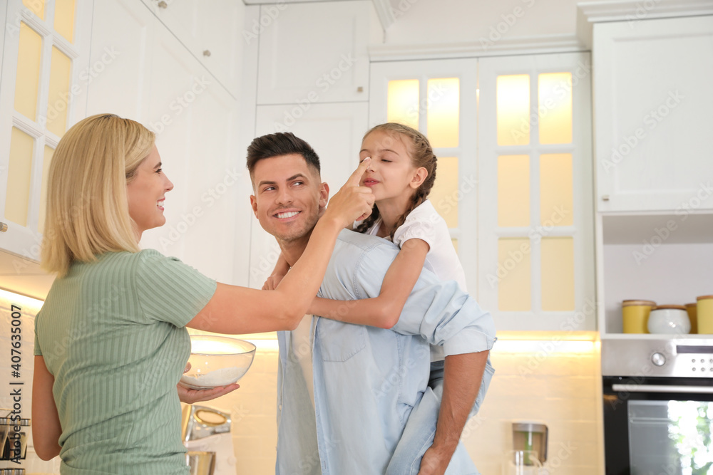 Happy family cooking together in modern kitchen Happy family cooking together in modern kitchen