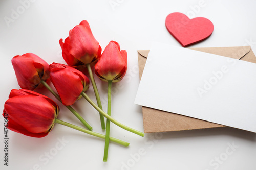happy valentine's day greeting card mockup. bouquet of red tulips, red heart and space for text