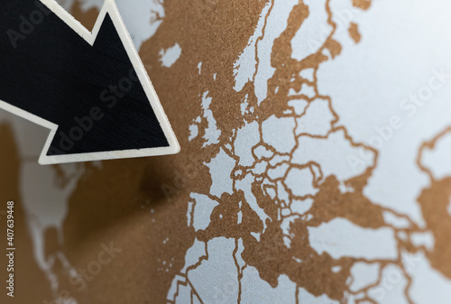 Giant black arrow with copy space pointing to Europe on a nice cork map.