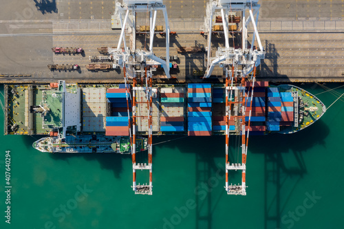 Container ship terminal, and quay crane of container ship at industrial port with shipping container vessel, Maritime cargo freight ship import export business service logistic international transport