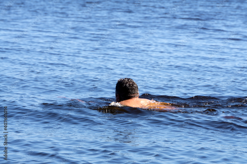 young man swimming in oceans water speed,