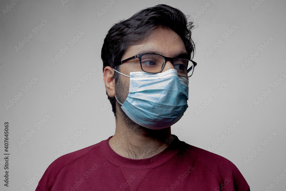 A man with mask on face looking on one side A man with mask on face looking on one side