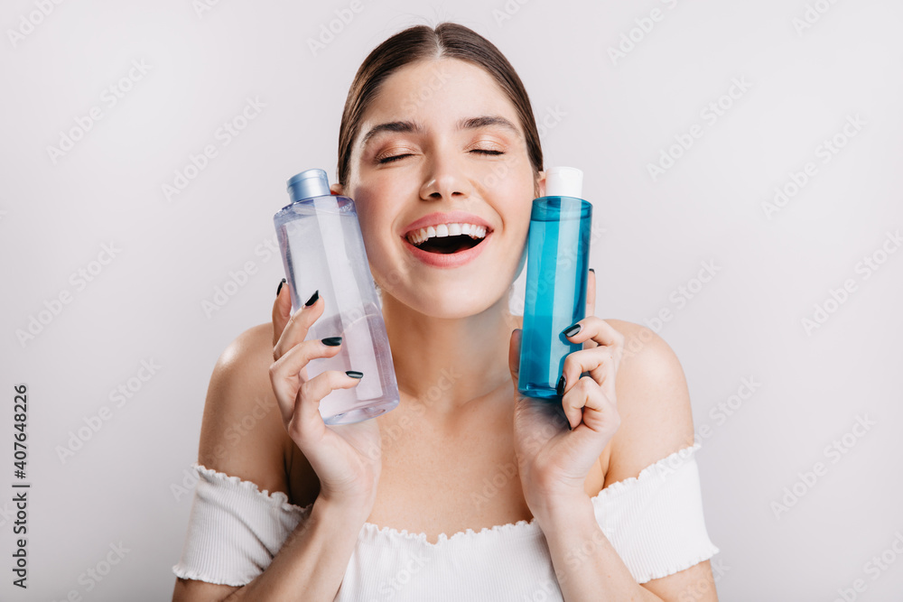 No makeup. Pretty lady with perfect skin keeps cosmetic tonic around her face to help maintain healthy look No makeup. Pretty lady with perfect skin keeps cosmetic tonic around her face to help maintain healthy look