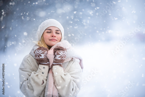 Beautiful woman in wintertime among snow
