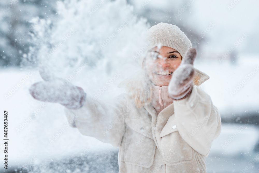 Enjoying winter time woman playing with snow Enjoying winter time woman playing with snow