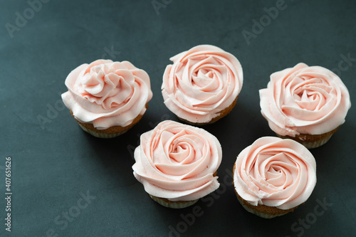 Cupcakes with butter cream on dark background