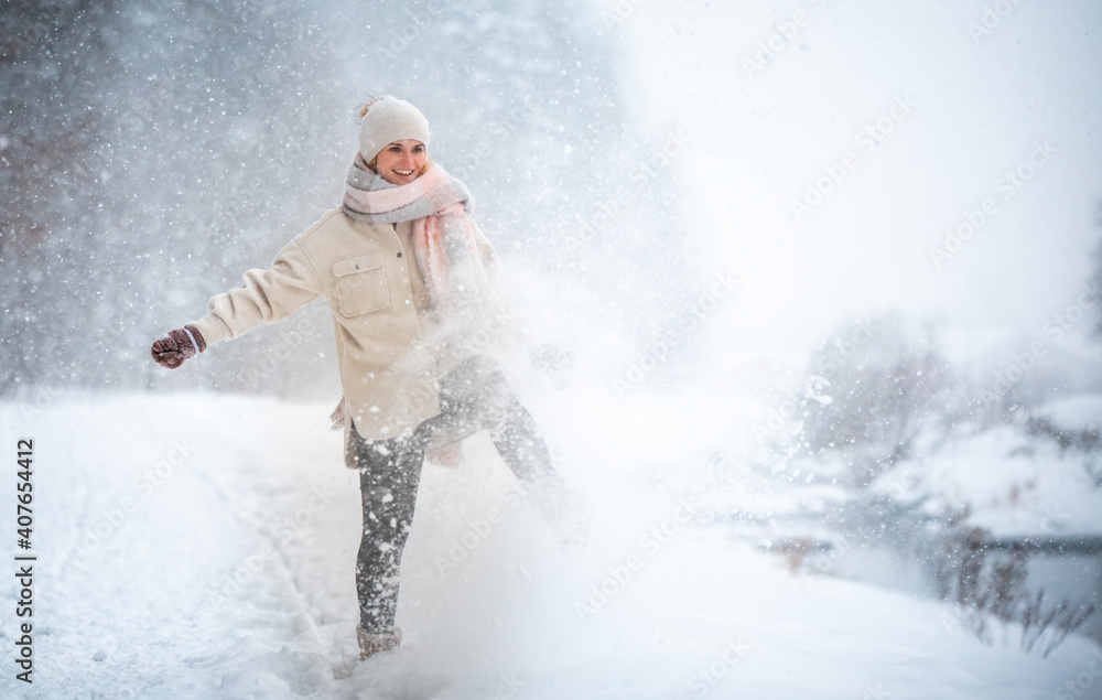 Smiling woman enjoying winter among snow outdoor Smiling woman enjoying winter among snow outdoor