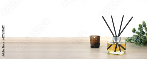 Photos luxury aroma scent reed diffuser glass bottle is on the wooden table and amber g