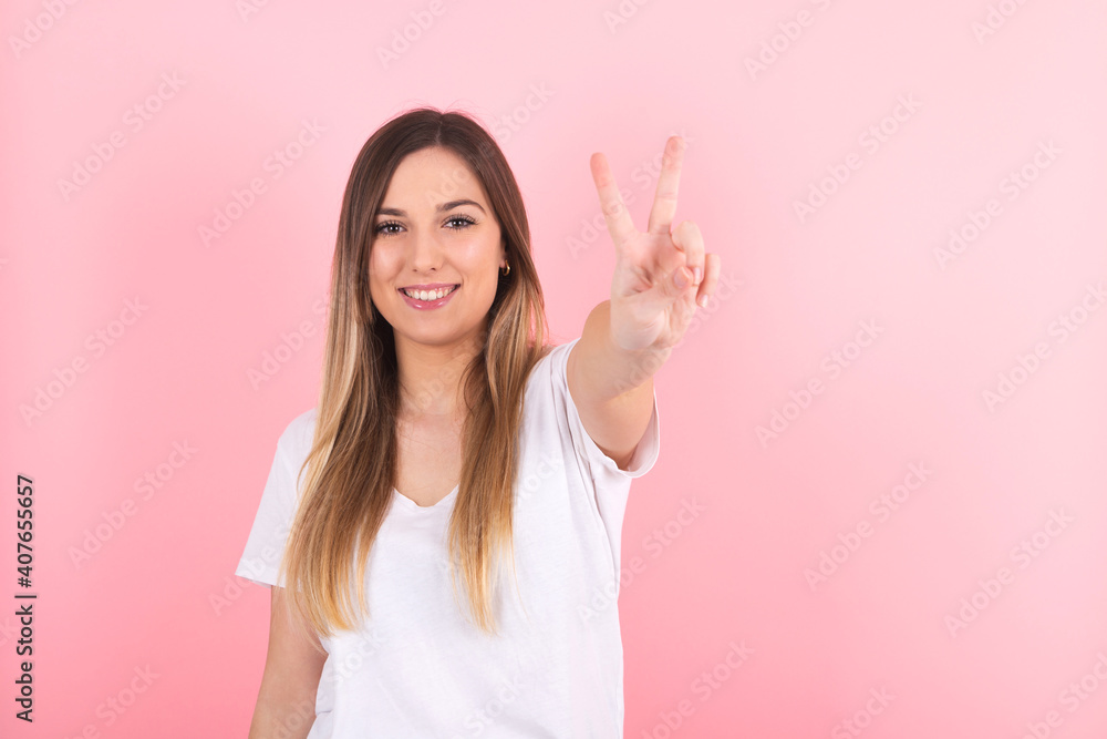 Young woman making a victory gesture with her hand