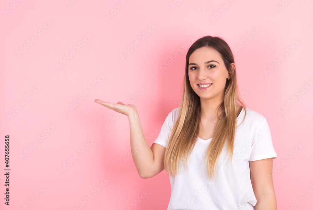 Young woman shows copy space with her hand Young woman shows copy space with her hand
