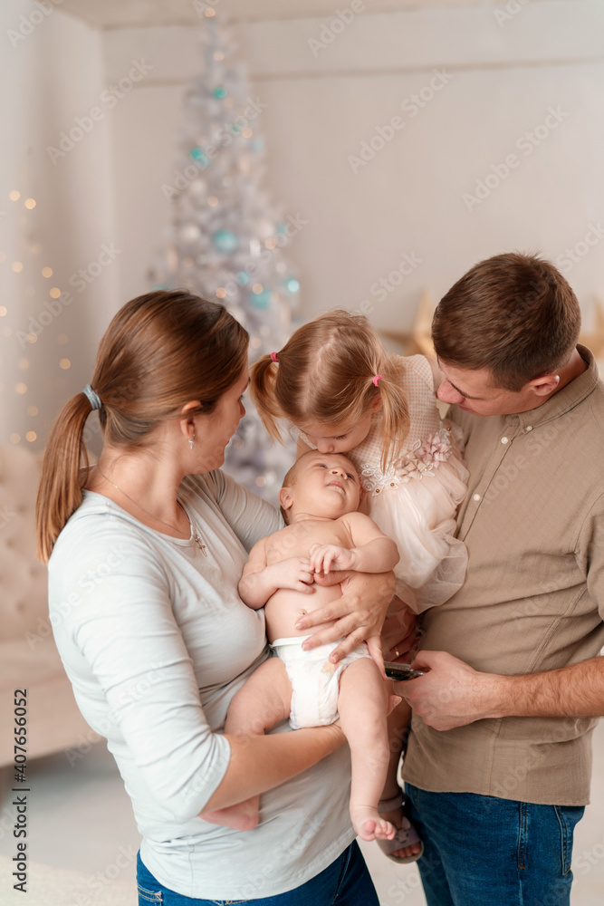 happy family with two children, the eldest daughter kisses her brother happy family with two children, the eldest daughter kisses her brother