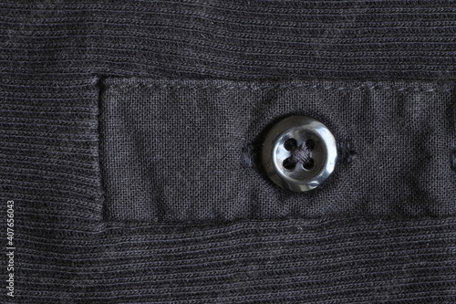The texture of the fabric with a button for clothes.