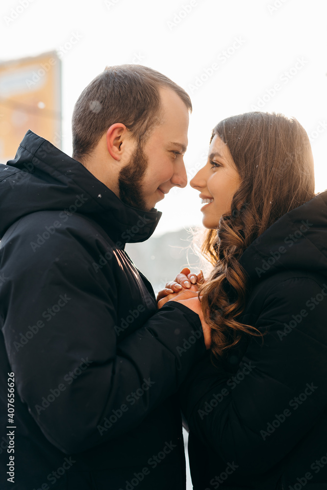 A man gently warms the hands of his beloved girl in cold weather A man gently warms the hands of his beloved girl in cold weather