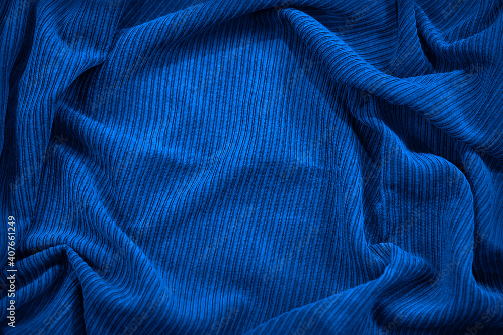 Beautiful blue fabric background. Wavy soft folds. Elegant navy blue background with copy space for design. Beautiful blue fabric background. Wavy soft folds. Elegant navy blue background with copy space for design.