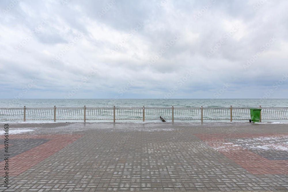 Winter seascape with Baltic Sea waters, horizon and cloudy sky in Kaliningrad region, Russia