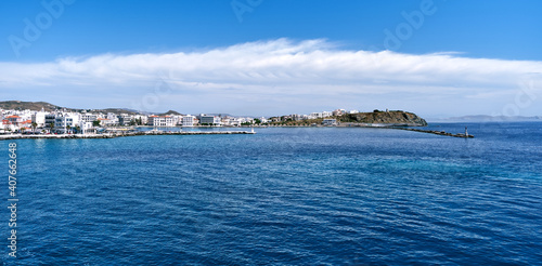 Panoramic sea view of main town of Tinos island and its harbor, Greece. Beautiful summer day, azure sea, vacations, Mediterranean island hopping.