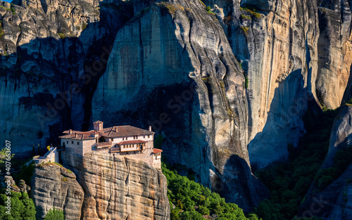 Close view of cliff top Roussanou nunnery or Moni Agias Varvaras, hills, massive sedimentary rocks. Meteora valley, Greece at day. UNESCO World Heritage photo