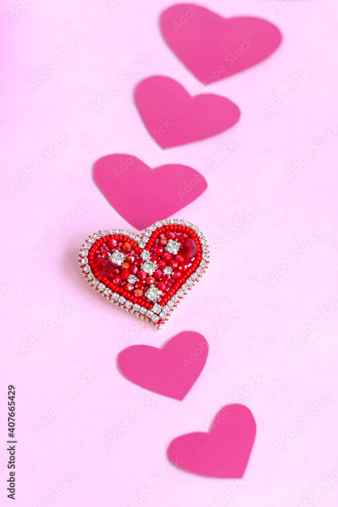 Red heart made of beads. Pink hearts. The concept of the Valentine's Day theme. A greeting card, a declaration of love.