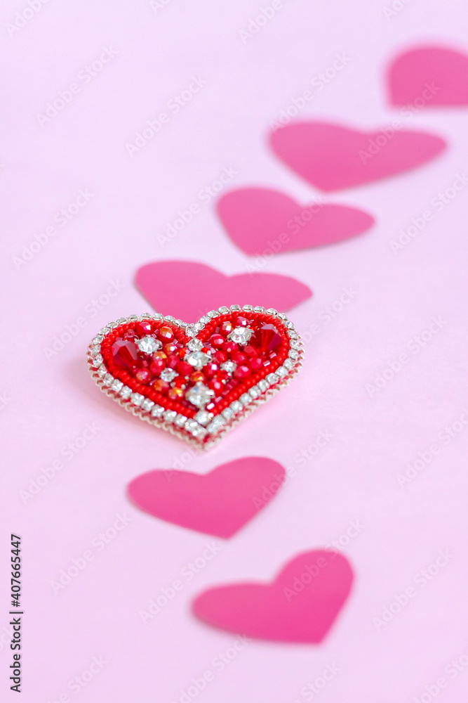 Red heart made of beads. Pink hearts. The concept of the Valentine's Day theme. A greeting card, a declaration of love.