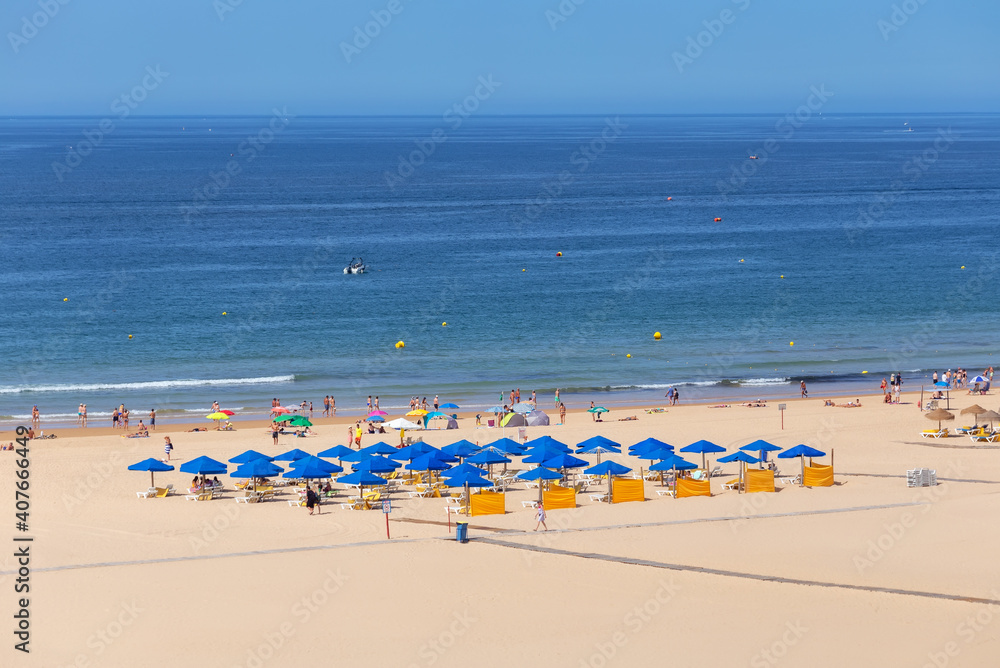 Nice clean aerial beach shot with lots of mainly blue umbrellas and a clear water and sky. Nice clean aerial beach shot with lots of mainly blue umbrellas and a clear water and sky.