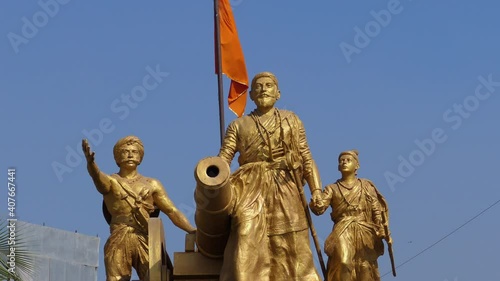 Beautiful sclupture of Chhatrapati Shivaji Maharaj with maratha bhagwa flag fluttering in the back photo